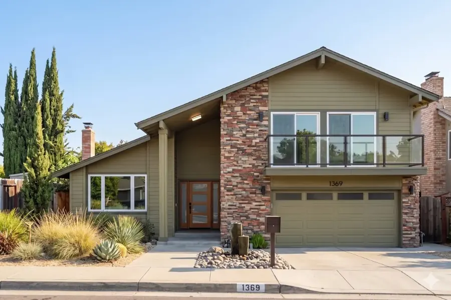 Two-story East Bay tract home with a stone-accent facade and attached garage