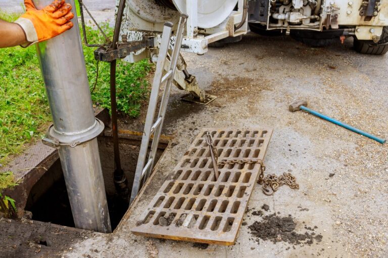 Professional plumbers working on an open sewer to address common sewer problems, showcasing sewer line repair, maintenance, and plumbing services. Flow Pro Plumbing offers expert sewer solutions, including sewer inspections, drain cleaning, and repairs to prevent plumbing issues like clogs and backups. We offer reliable solutions to sewer problems, how to prevent sewer line issues, sewer line maintenance, common sewer problems, sewer repairs, clogged sewer lines, sewer cleaning services, sewer inspection, drain cleaning services, plumbing services near me, sewer backup prevention, sewer pipe repair, trenchless sewer repair, plumbing experts near me, professional plumbing services, residential sewer repairs, prevent sewer clogs, emergency plumbing services, affordable sewer repairs, Flow Pro Plumbing sewer services, fix sewer problems near me, plumbing company near me, expert sewer repairs, sewer problem solutions near me, plumbing maintenance services near me.