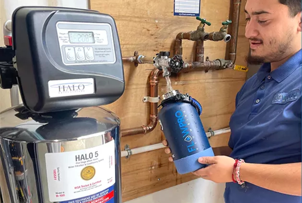 Home Plumber from Flow Pro Plumbing testing water from a newly installed water softener, highlighting expert water softener sizing and installation services in Brentwood, Antioch, Oakley, and nearby areas. Learn how to size a water softener for your home and improve water quality with professional plumbing solutions. Call today for professional help with how to size a water softener, water softener sizing guide, water softener grain capacity, choosing the right water softener size, what size water softener do I need, water softener calculator, water softener installation near me, water softener services near me, water softener installation in Brentwood, water softener service in Antioch, water softener repair in Oakley, water softener experts in Concord, residential water softener sizing, professional water softener installation, water softener maintenance near me, water softener installation services, best water softener size for a family of 4, how to calculate water softener size, water softener for hard water near me, Flow Pro Plumbing water softener services, water softener system sizing, efficient water softeners for home, water softener replacement near me, water softener service areas in Bay Point, water softener consultation in Discovery Bay, water softener system installation near me.