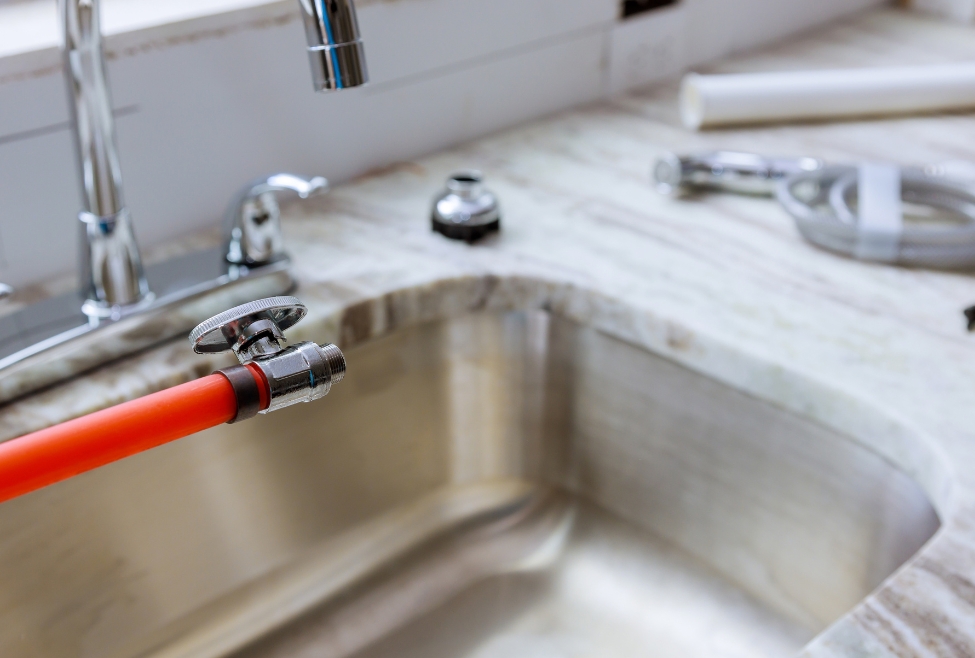 Home Kitchen sink installation with pipe connections and faucet on granite countertops – Flow Pro Plumbing provides professional sink installation, faucet replacement, and kitchen plumbing services for homeowners searching for ‘do I need a plumber to install a sink’ or ‘sink plumbing installation near me. Call now for help with sink installation, do I need a plumber to install a sink, professional sink installation, install kitchen sink near me, bathroom sink installation near me, plumbing services for sink installation, faucet installation, faucet replacement near me, kitchen plumbing services, plumber for sink replacement, granite countertop sink install, sink drain installation, affordable sink installation, expert sink plumbing, under-mount sink installation, top-mount sink install near me, residential plumbing services, local plumber for sink install, Flow Pro Plumbing sink services, licensed plumber sink hookup, new sink and faucet installation, install utility sink, plumbing help for sink installation, DIY sink install vs plumber, cost to install sink and faucet, sink installation Brentwood CA, plumbing contractor for sink install.
