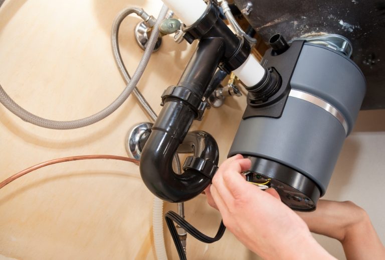 Flow Pro Plumbing technician repairing a jammed garbage disposal under a kitchen sink, addressing issues like a humming disposal that won’t spin, common garbage disposal problems, and stuck food waste; professional garbage disposal repair and kitchen plumbing services in Brentwood, CA. Reach out today for help with garbage disposal humming, garbage disposal making noise but not working, garbage disposal hums but doesn’t spin, garbage disposal not spinning, garbage disposal won’t turn, jammed garbage disposal, how to fix a humming garbage disposal, garbage disposal repair, kitchen plumbing repair, clogged garbage disposal, stuck garbage disposal, disposal motor not working, reset garbage disposal, garbage disposal troubleshooting, garbage disposal maintenance, garbage disposal repair near me, garbage disposal installation near me, kitchen plumbing services near me, Flow Pro Plumbing garbage disposal services, emergency garbage disposal repair, professional plumber for garbage disposal repair, how to fix garbage disposal near me, garbage disposal repair Brentwood CA, Antioch garbage disposal plumber, Oakley kitchen plumbing, Pittsburg clogged disposal repair, Concord garbage disposal troubleshooting, Pleasant Hill garbage disposal service.