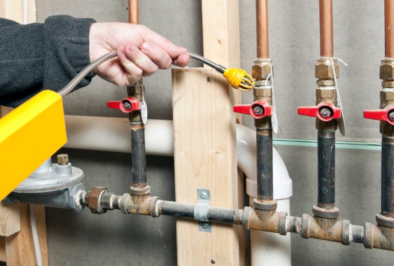 Plumber using gas leak detector on residential gas lines, highlighting safety concerns of DIY gas line installation, professional gas line repair, home gas line inspection, and licensed gas pipe services. Contact us now for help with can I install a gas line myself, DIY gas line installation risks, gas line installation near me, professional gas line installer, gas line services near me, gas line repair near me, licensed plumber gas line installation, underground gas line installation, how to run a natural gas line, gas line replacement near me, gas pipe installation service, home gas line repair, flexible gas line installation, gas line connection for stove, residential gas line plumber, running gas line to garage, gas line for BBQ installation, permit for gas line installation, cost to run gas line near me, plumber for gas pipe installation, natural gas plumber near me, Flow Pro Plumbing gas services.