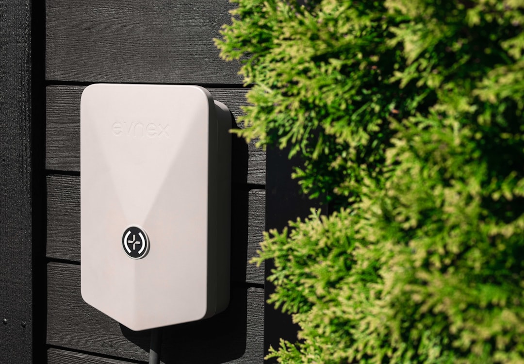 Home modern smart irrigation controller mounted on a garage wall - summer water conservation tips for homeowners